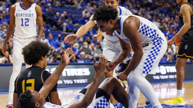 Nov 22, 2021; Lexington, Kentucky, USA; Kentucky Wildcats guard Sahvir Wheeler (2) celebrates as he helps forward Oscar Tshiebwe (34) to his feet during the first half against the Albany Great Danes at Rupp Arena at Central Bank Center. Mandatory Credit: Jordan Prather-USA TODAY Sports